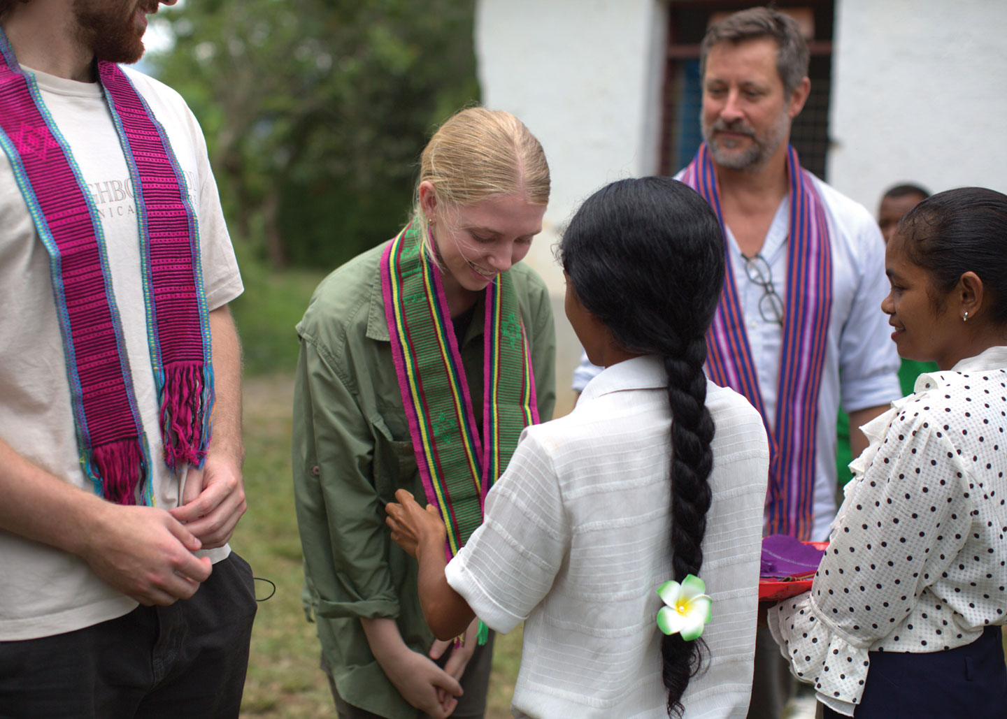 Mary McCusker receiving a hand woven tais at a UNICEF-supported community-based preschool in Ermera, Timor-Leste. Photo: ©UNICEF Timor-Leste/2025/NSoares