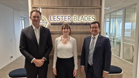 James Fairbairn, Jemma Buckner and Geoff Blades in front of signage.