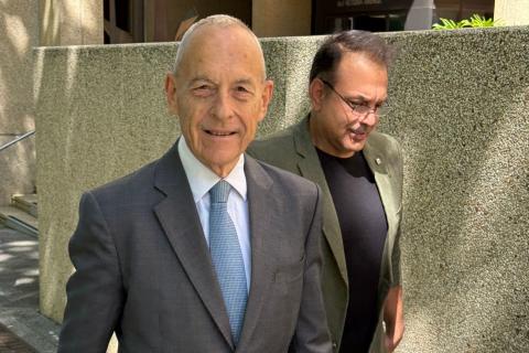 Doug Solomon, foreground, and Carmelo Pizzino leave the Federal Court.