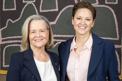 Nicola Forrest and Philippa Watson in front of Indigenous art work