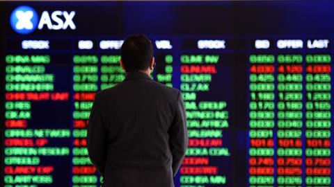 A man views the ASX trading board in Sydney