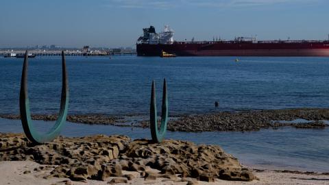 A woman photographs the ‘Eyes of the land and the sea’ scuplture