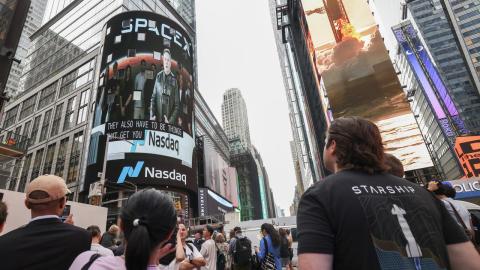 Elon Musk is shown on a Times Square screen.