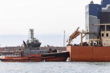 A BHP tug boat escorts a bulk carrier out of the Port of Port Hedland. Photo: Tom Zaunmayr